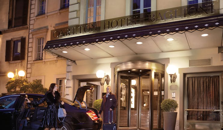 Entrance to the hotel at night from the outside showing revolving doors to ente