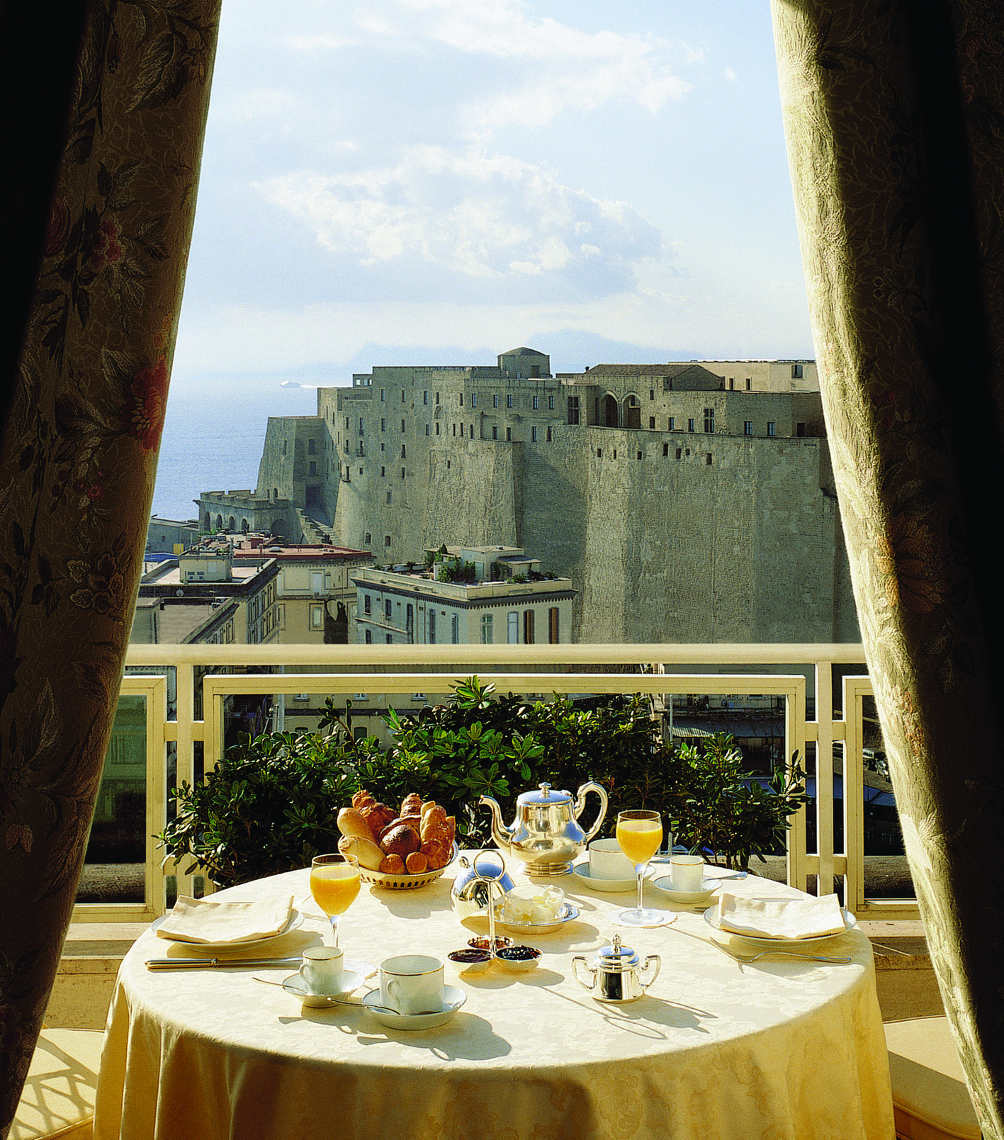 View of the Caruso Roof Garden Restaurant with a circular table on the balcony looking over Naples