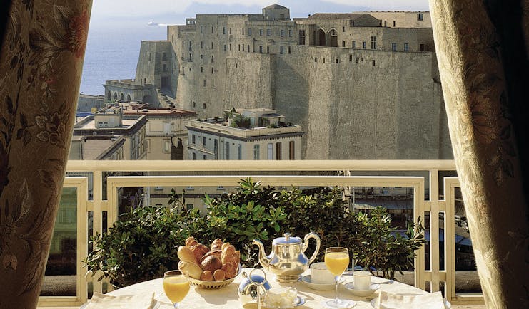 View of the Caruso Roof Garden Restaurant with a circular table on the balcony looking over Naples