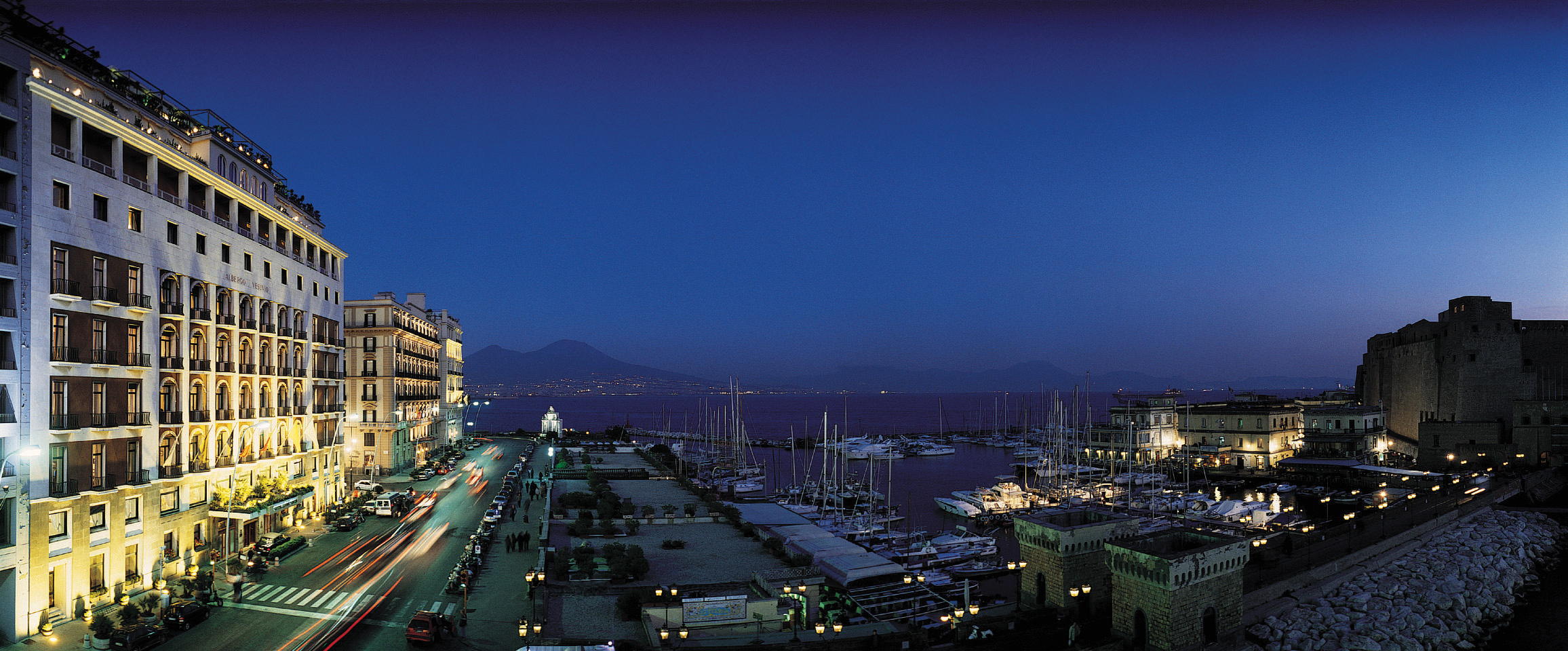 Exterior at night with view over harbout with boats in 