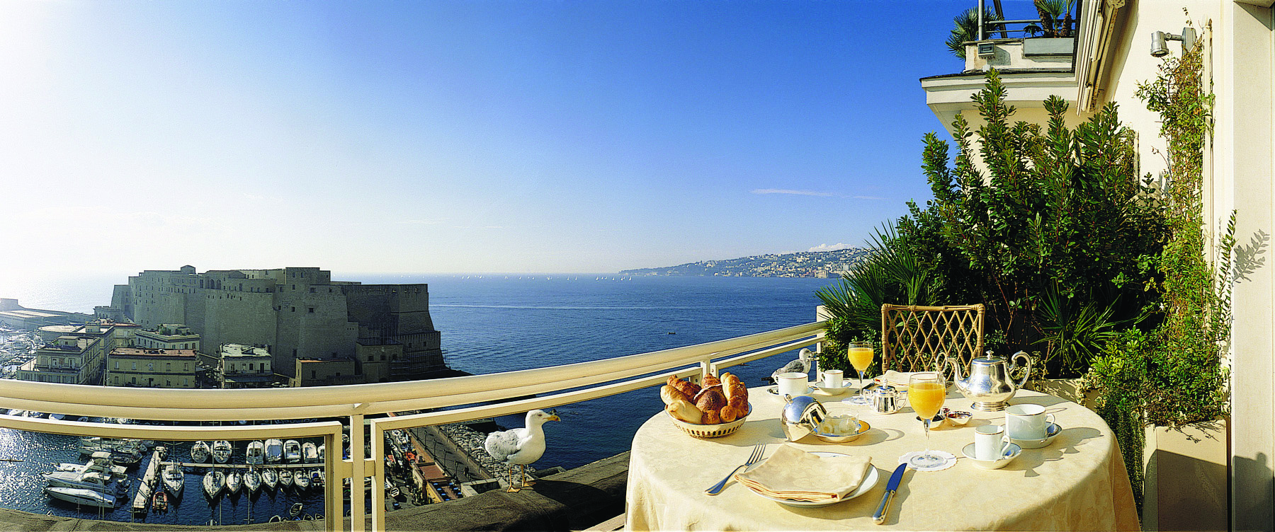 View from a balcony at the Grand Hotel Vesuvio looking over Naples and the blue sea