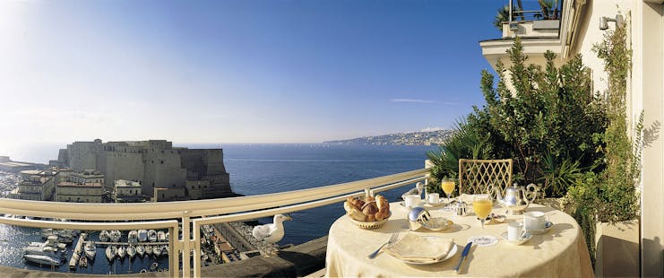 View from a balcony at the Grand Hotel Vesuvio looking over Naples and the blue sea