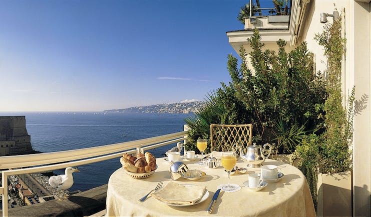 View from a balcony at the Grand Hotel Vesuvio looking over Naples and the blue sea