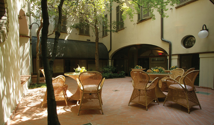 Palace Hotel Maria Luigia Parma courtyard outdoor seating area trees