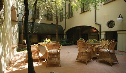 Palace Hotel Maria Luigia Parma courtyard outdoor seating area trees
