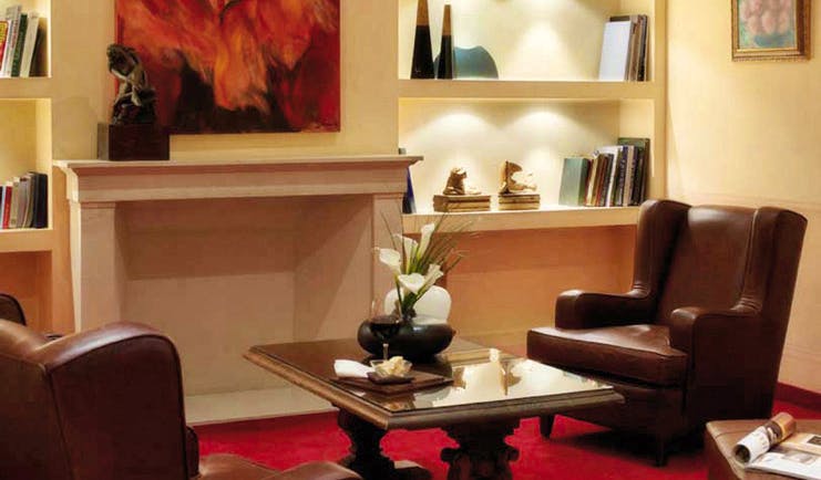 Palace Hotel Maria Luigia Parma library indoor seating area armchairs books