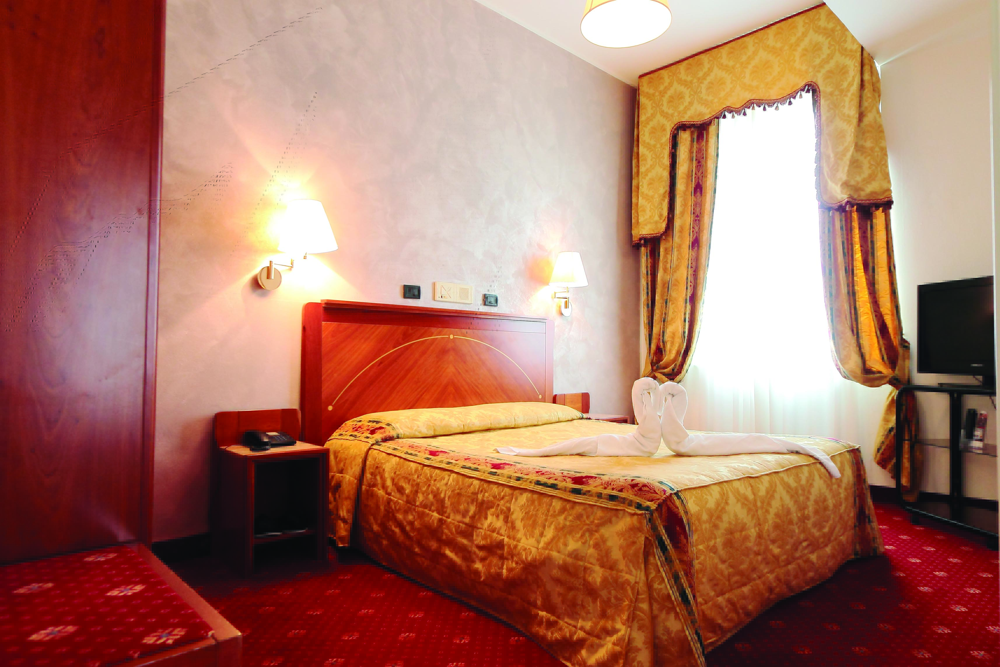 Rechigi Park Hotel guestroom, double bed, draped curtains, traditional decor