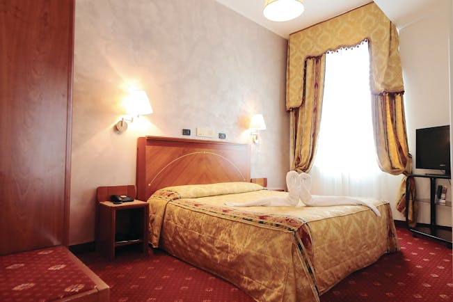 Rechigi Park Hotel guestroom, double bed, draped curtains, traditional decor