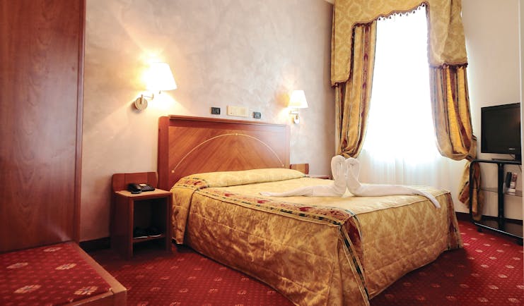 Rechigi Park Hotel guestroom, double bed, draped curtains, traditional decor