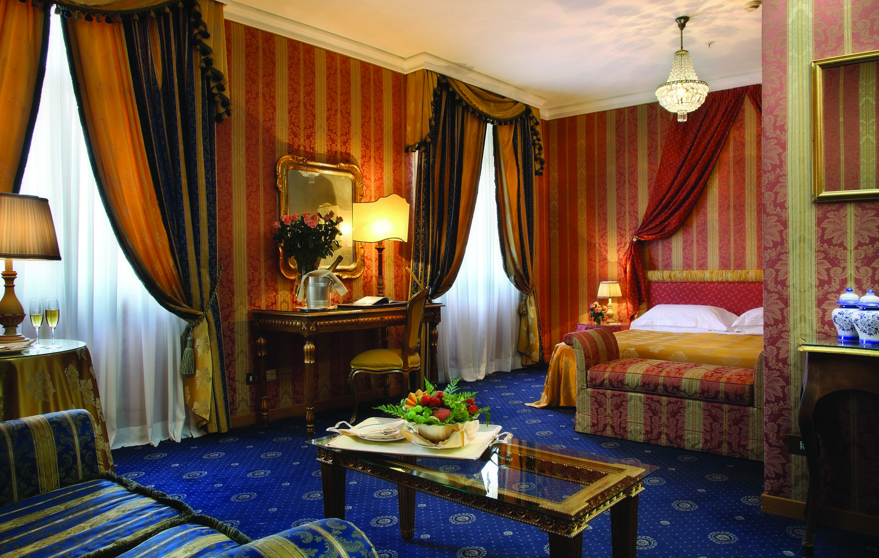 Bernini Bristol Rome junior suite bed and living area drapery blue carpets