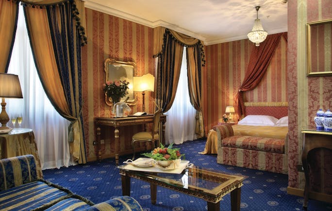 Bernini Bristol Rome junior suite bed and living area drapery blue carpets