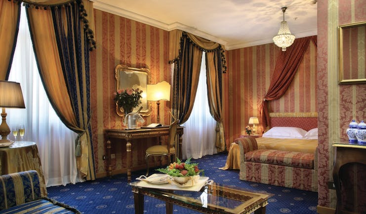 Bernini Bristol Rome junior suite bed and living area drapery blue carpets