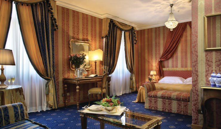 Bernini Bristol Rome junior suite bed and living area drapery blue carpets