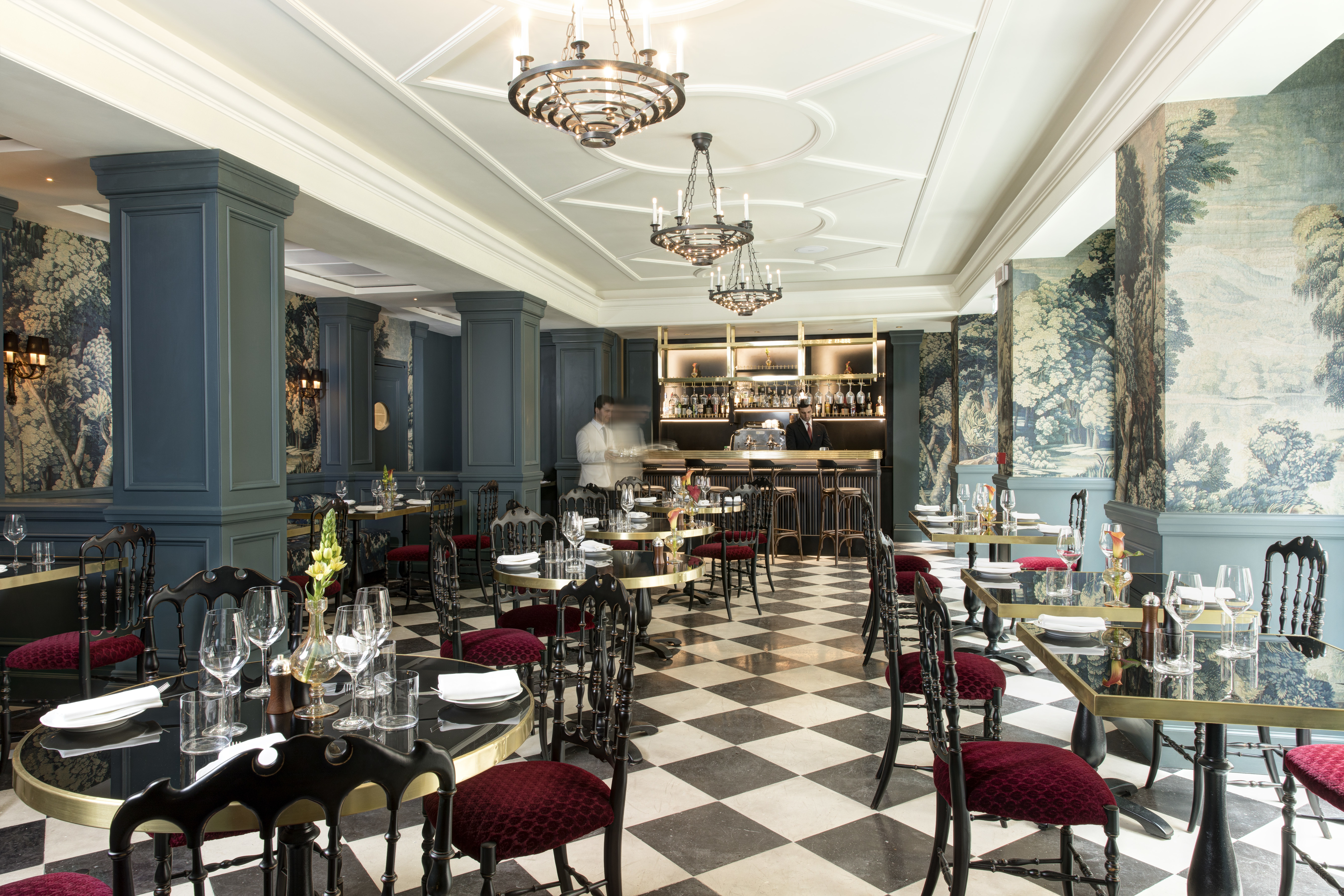 Hotel de la Ville Rome restaurant with red chairs and black and white floor