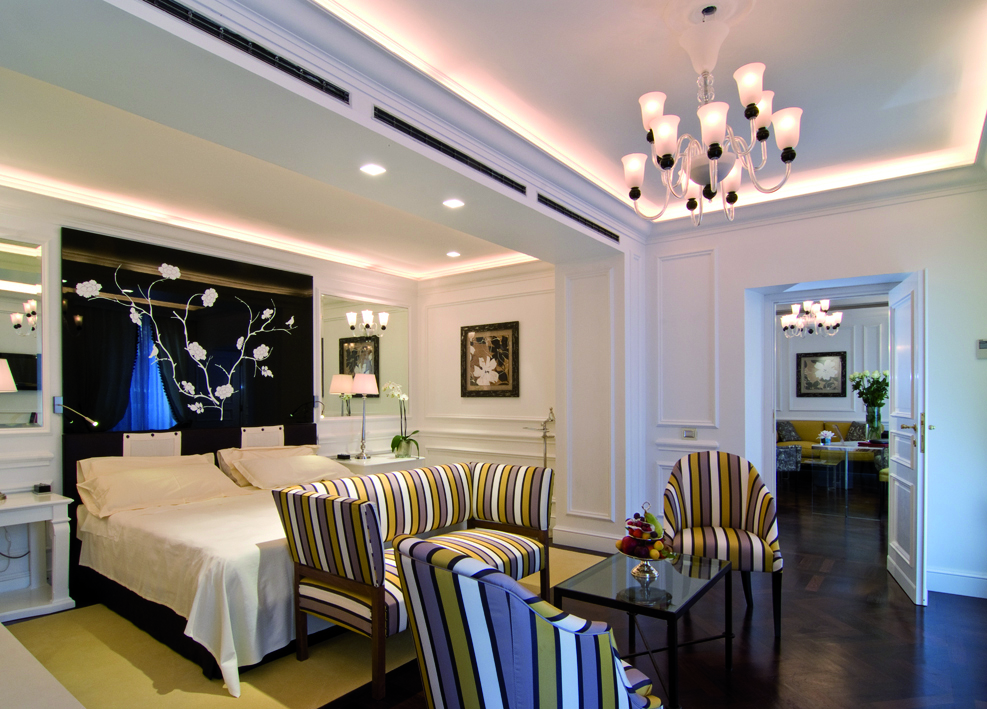 Hotel d'Inghilterra Rome executive suite bedroom bed armchairs ornate modern décor