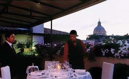 Hotel d'Inghilterra Rome terrace dining table set for two waiters city views