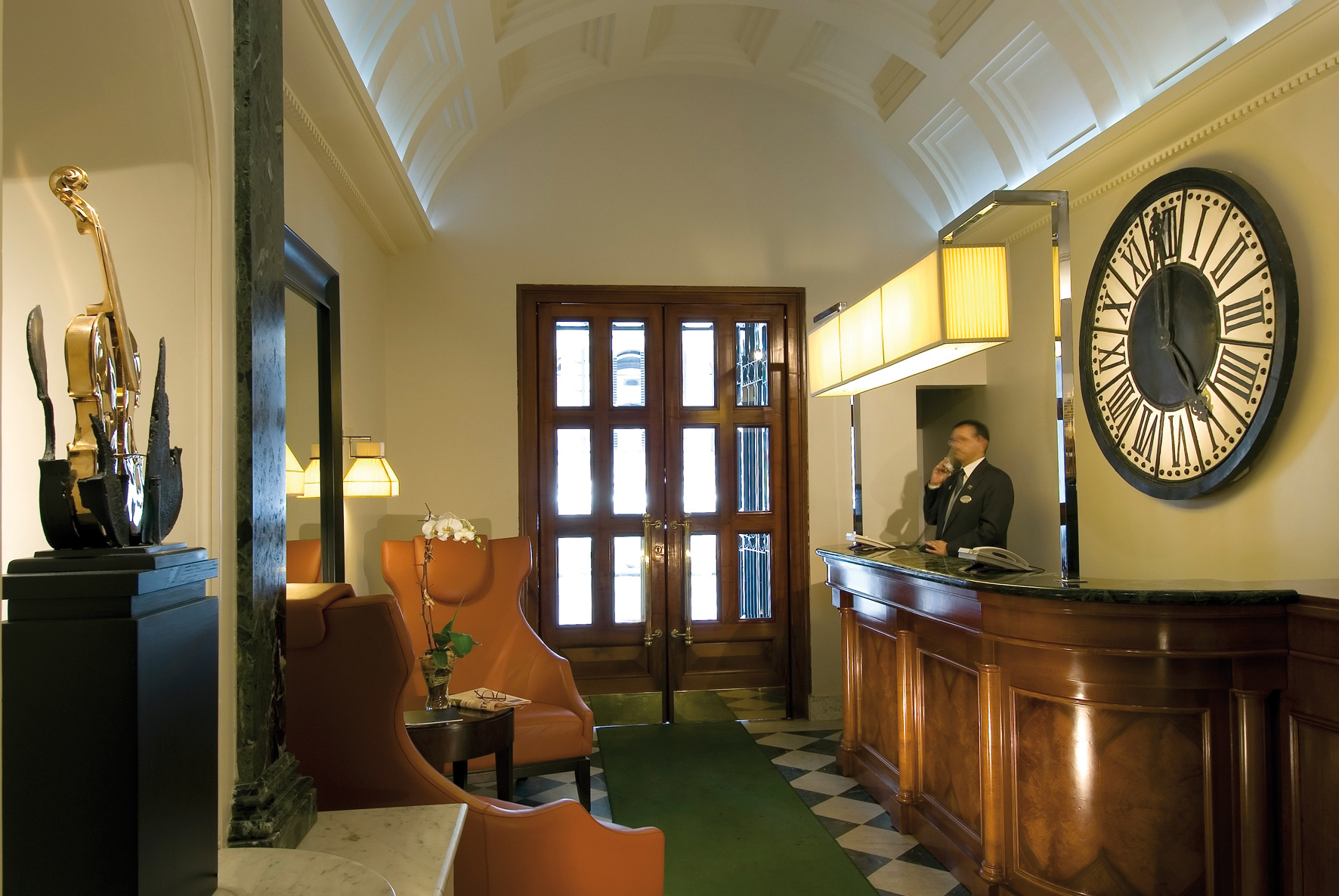 Reception area with doors to exit and man behind the desk 