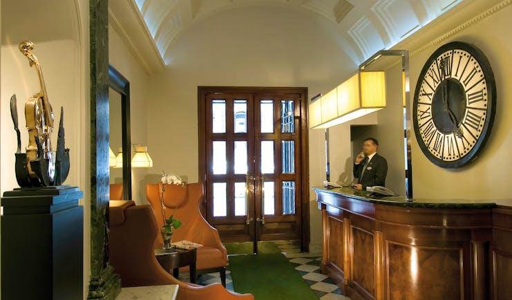 Reception area with doors to exit and man behind the desk 