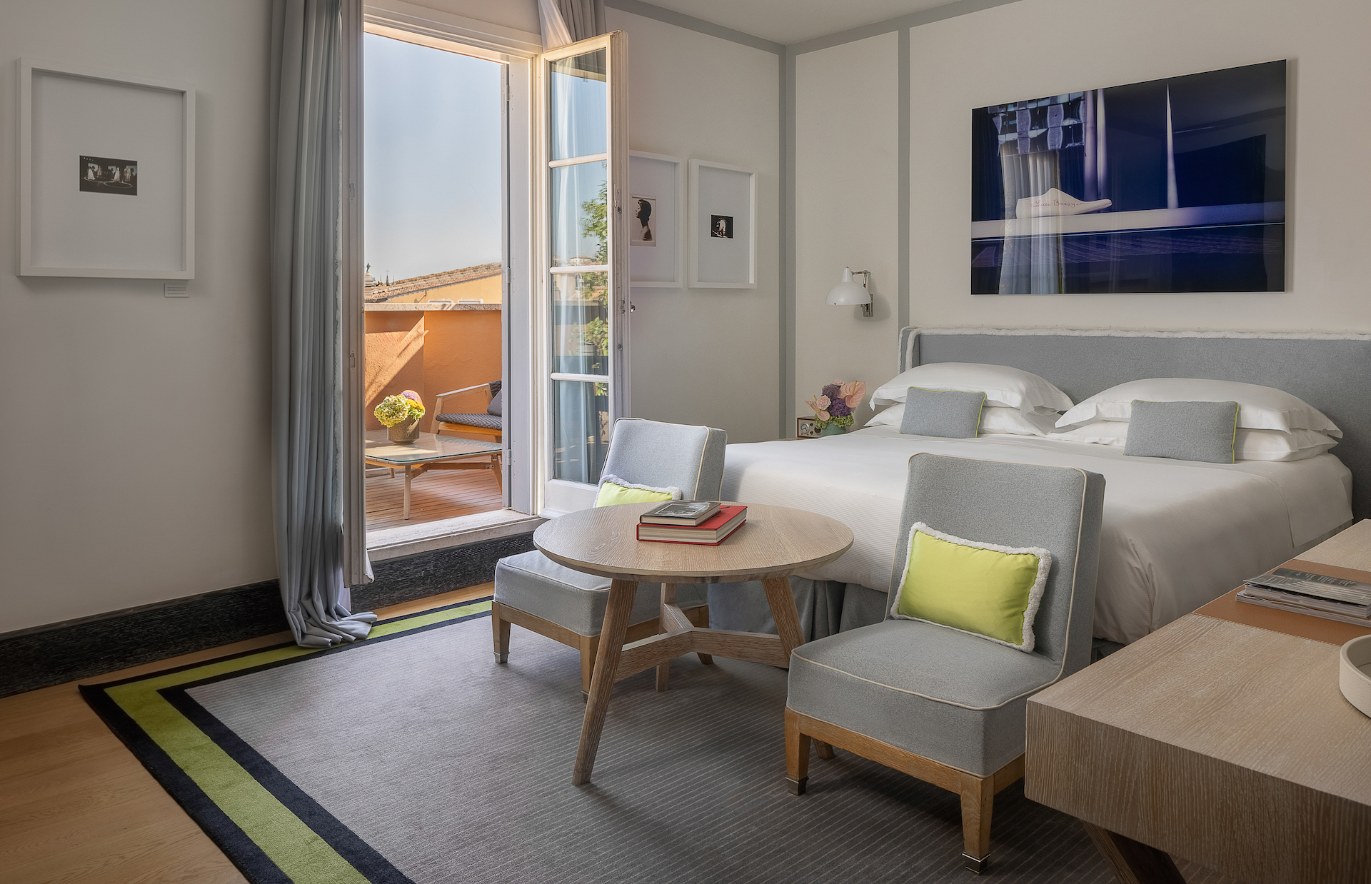 Hotel Portrait Roma Portrait Family Terrace room with double bed, seating area, and terrace visible out of an open door