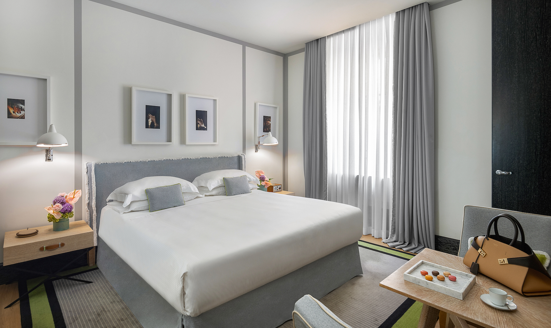 Hotel Portrait Roma Portrait Studio room with white and grey double bed and small seating area