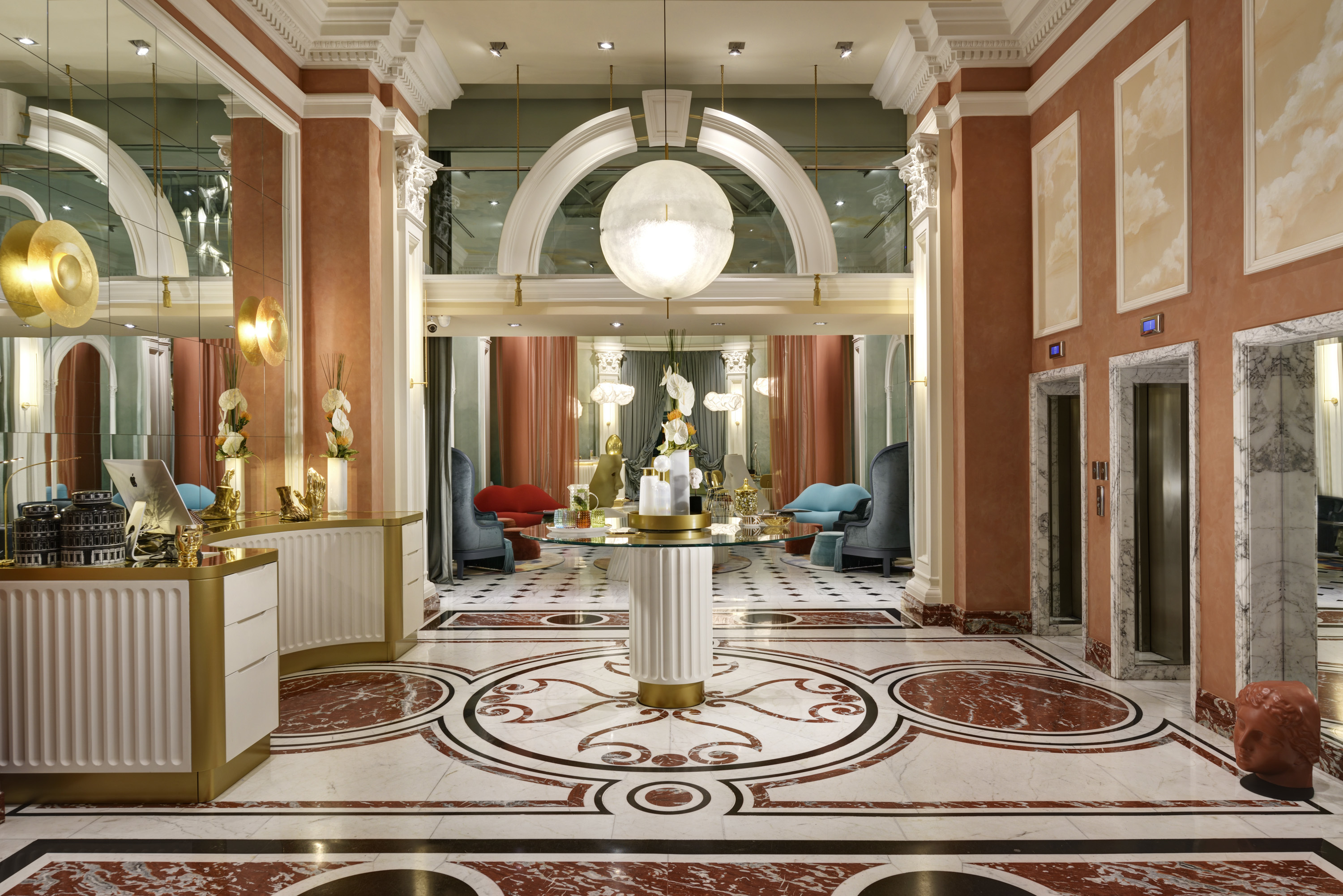 Leon's Place lobby with ornate white, black, gold and pink marble floor, high arched ceilings, and a sense of opulence and fun