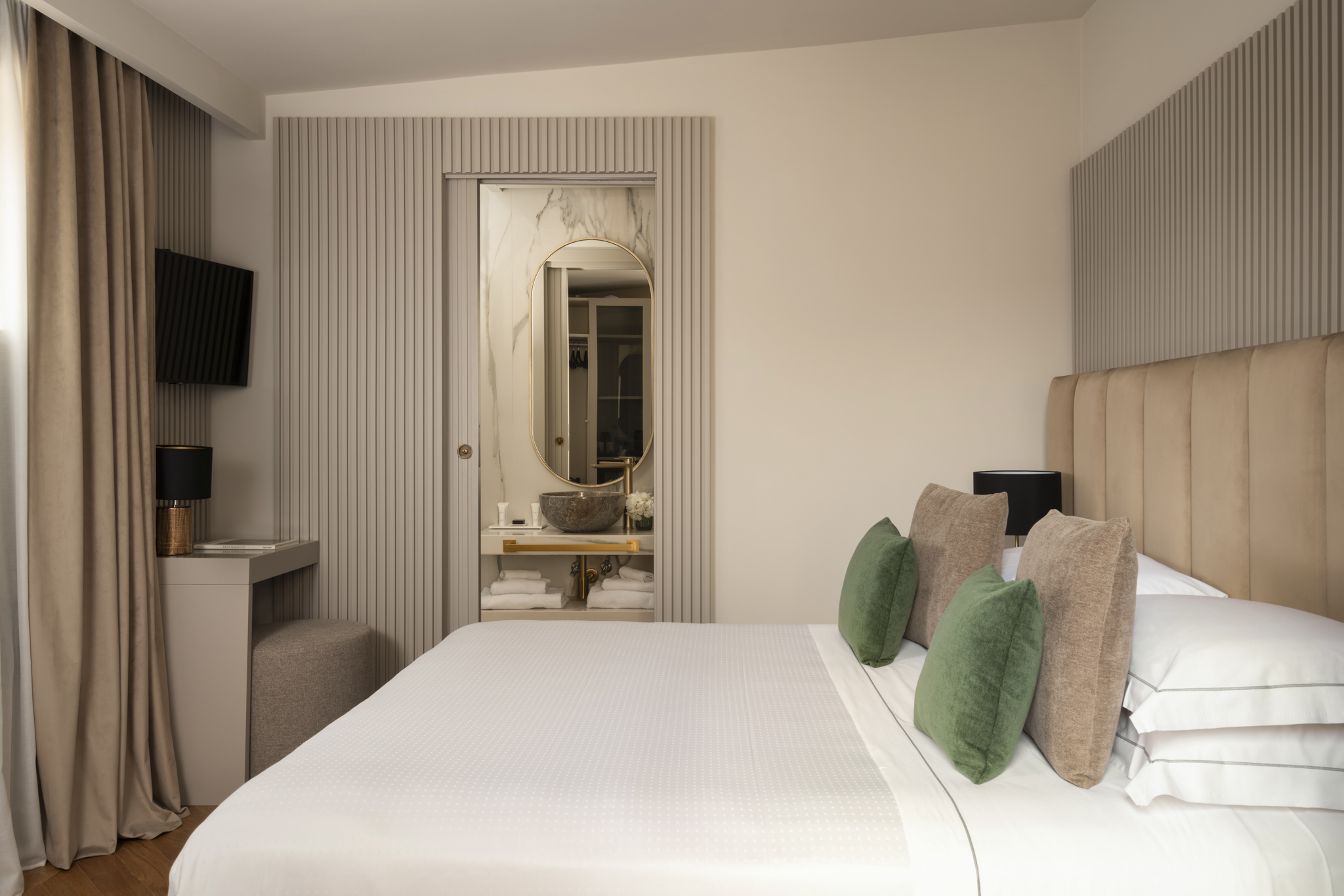 Palazzo Venere Superior Room with light neutral colour palette, double bed, desk, and mirror