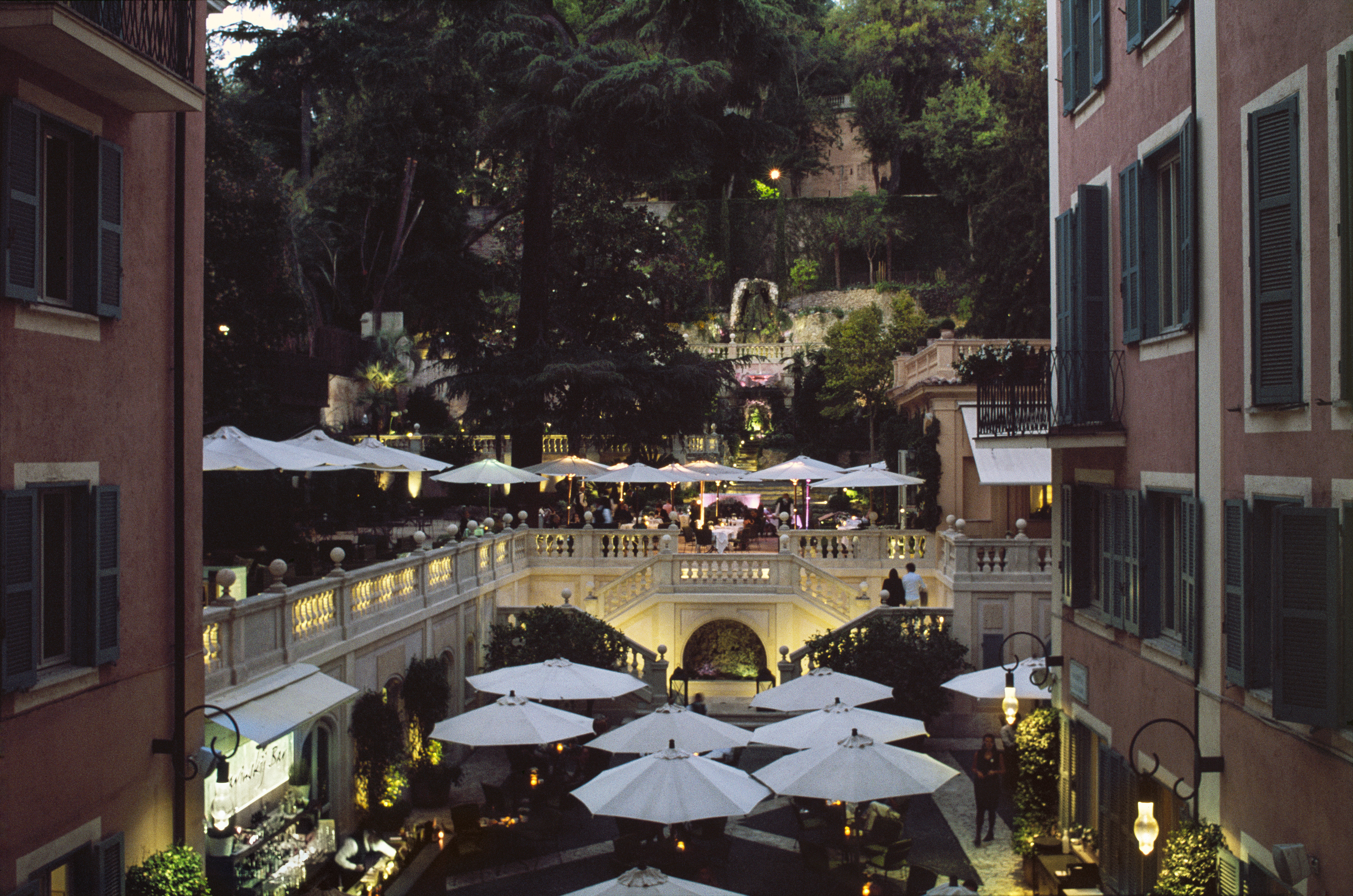 Hotel de Russie Rome evening with lights and shades in the courtyard