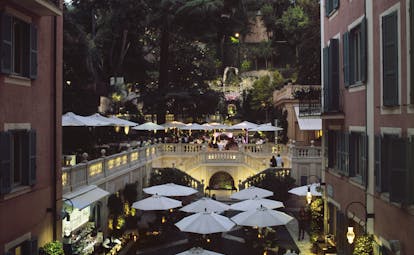 Hotel de Russie Rome evening with lights and shades in the courtyard