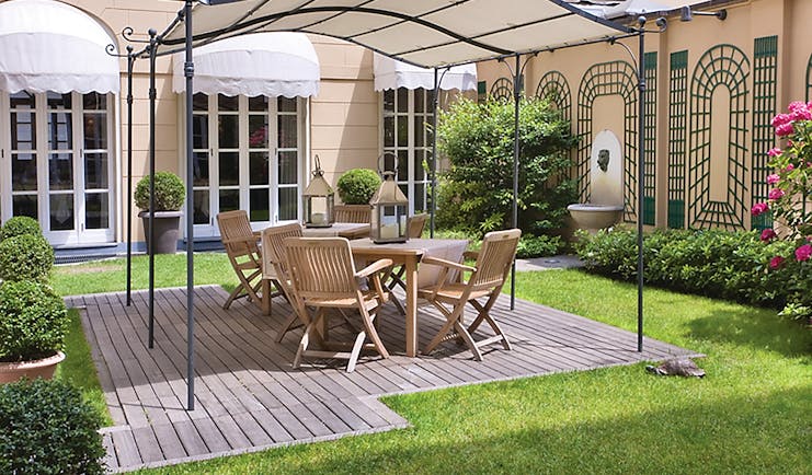 Grand Hotel Sitea Turin garden area with shade and chairs by grass