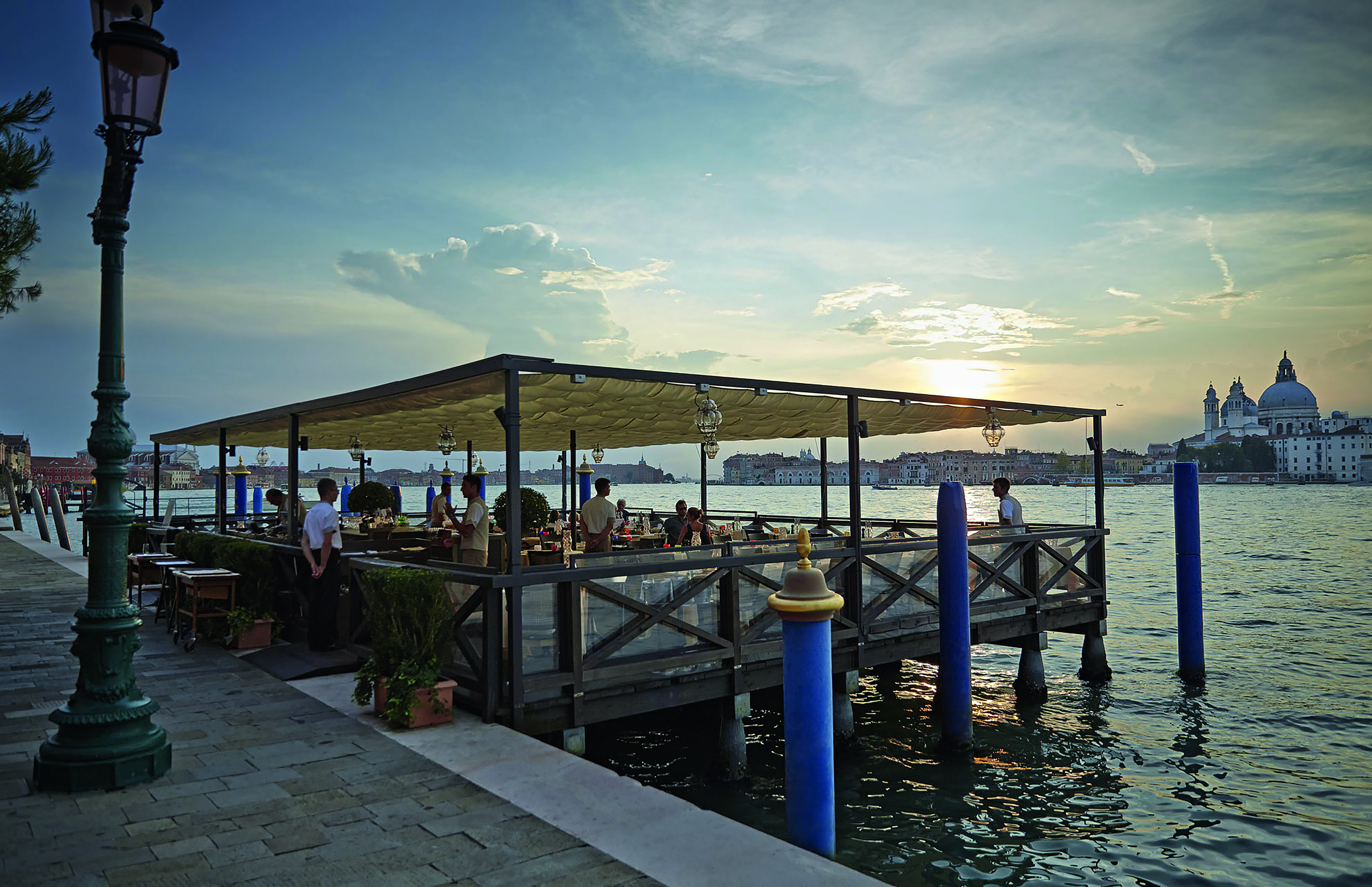 Dining area on a platform in the water with seating area on the platform 