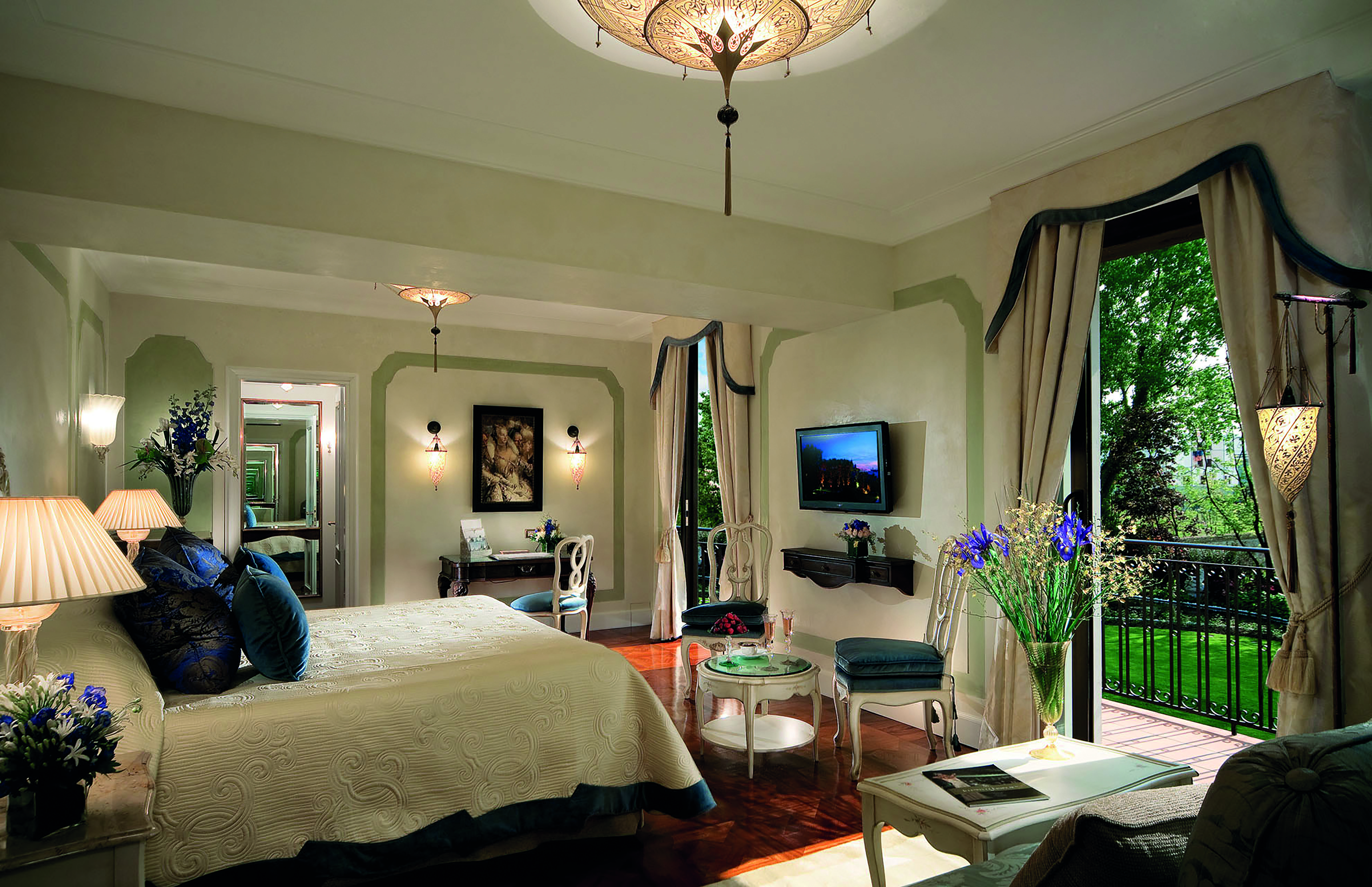 Belmond Hotel Cipriani Suite with king sized met, double doors leading out onto a balcony and a chandelier