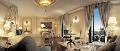 Belmond Hotel Cipriani cream and gray colour-themed suite with a king sized bed