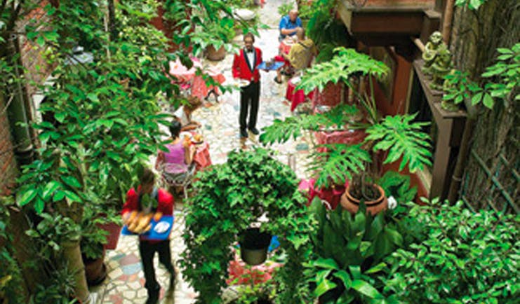 Hotel Flora Venice patio dining waiters diners shrubs