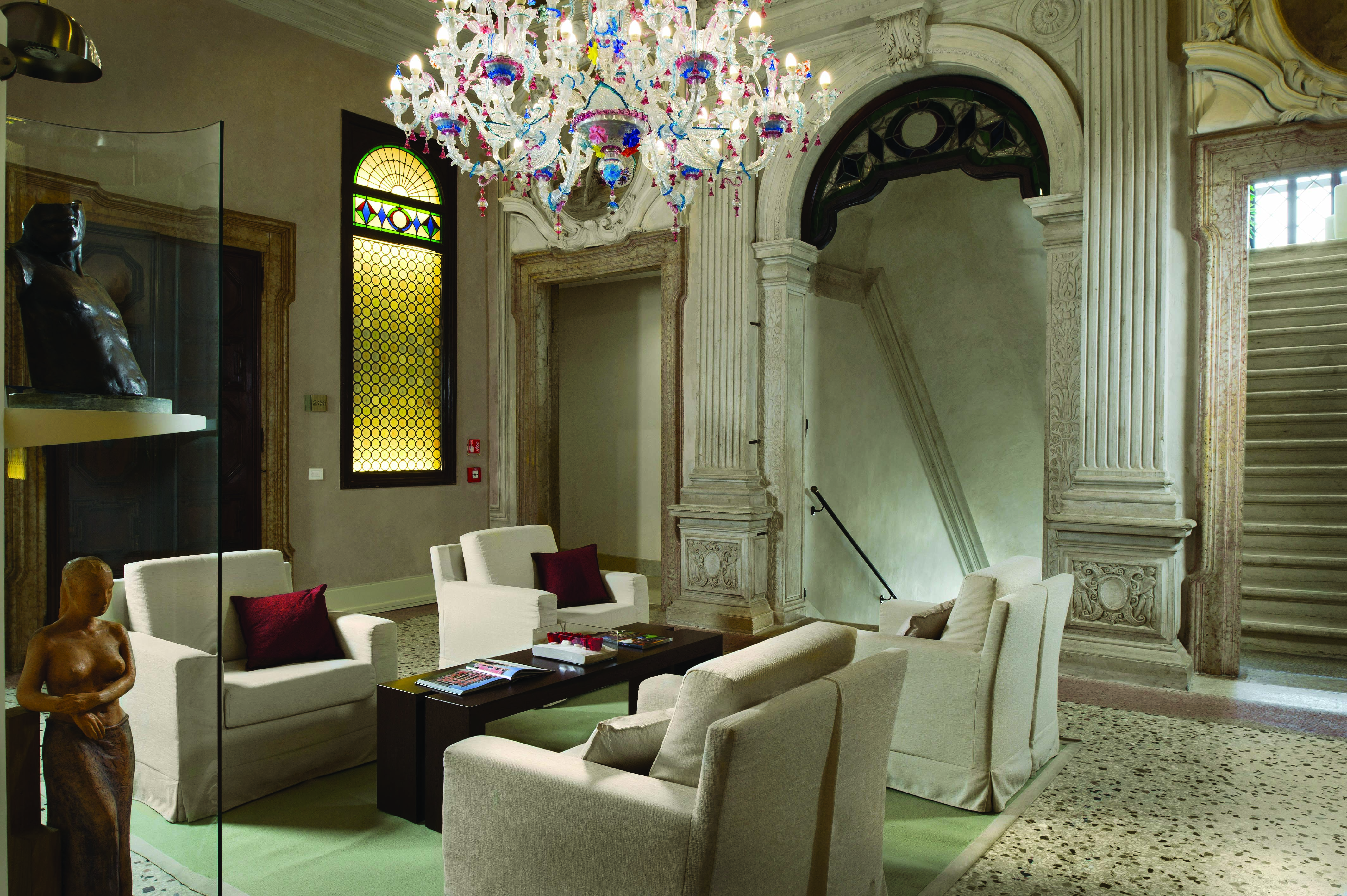 Palazzo Giovanelli Venice lounge communal indoor seating area marble floors candelabra