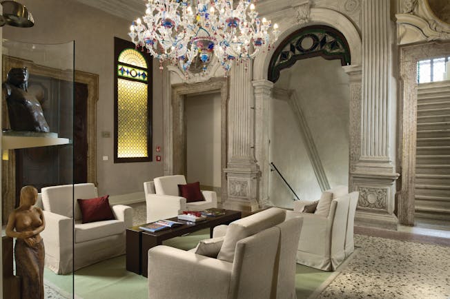 Palazzo Giovanelli Venice lounge communal indoor seating area marble floors candelabra