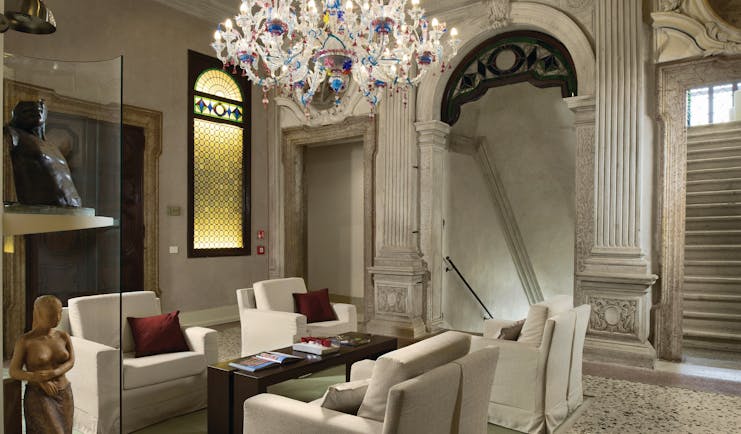 Palazzo Giovanelli Venice lounge communal indoor seating area marble floors candelabra