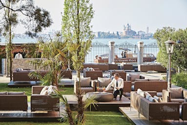 San Clemente Palace Venice garden bar outdoor seating area views of city waiter