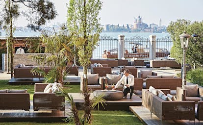 San Clemente Palace Venice garden bar outdoor seating area views of city waiter