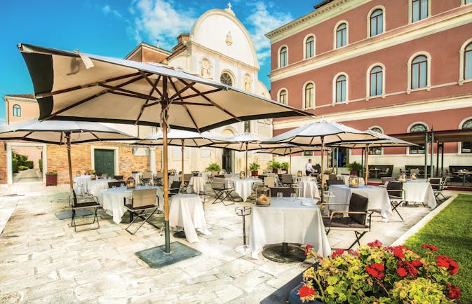 San Clemente Palace Venice terrace outdoor dining umbrellas 