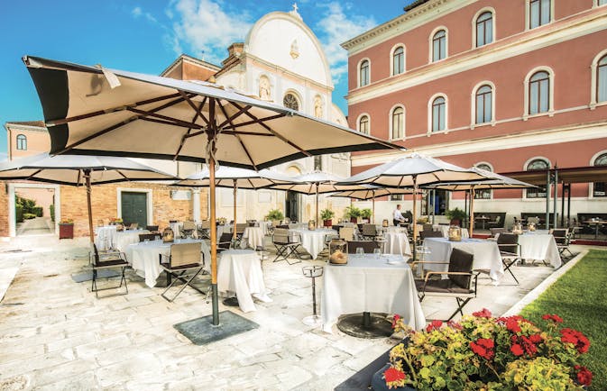 San Clemente Palace Venice terrace outdoor dining umbrellas 