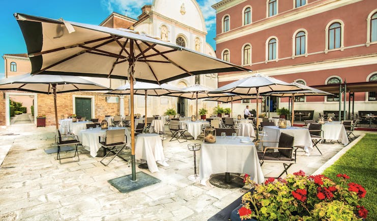 San Clemente Palace Venice terrace outdoor dining umbrellas 