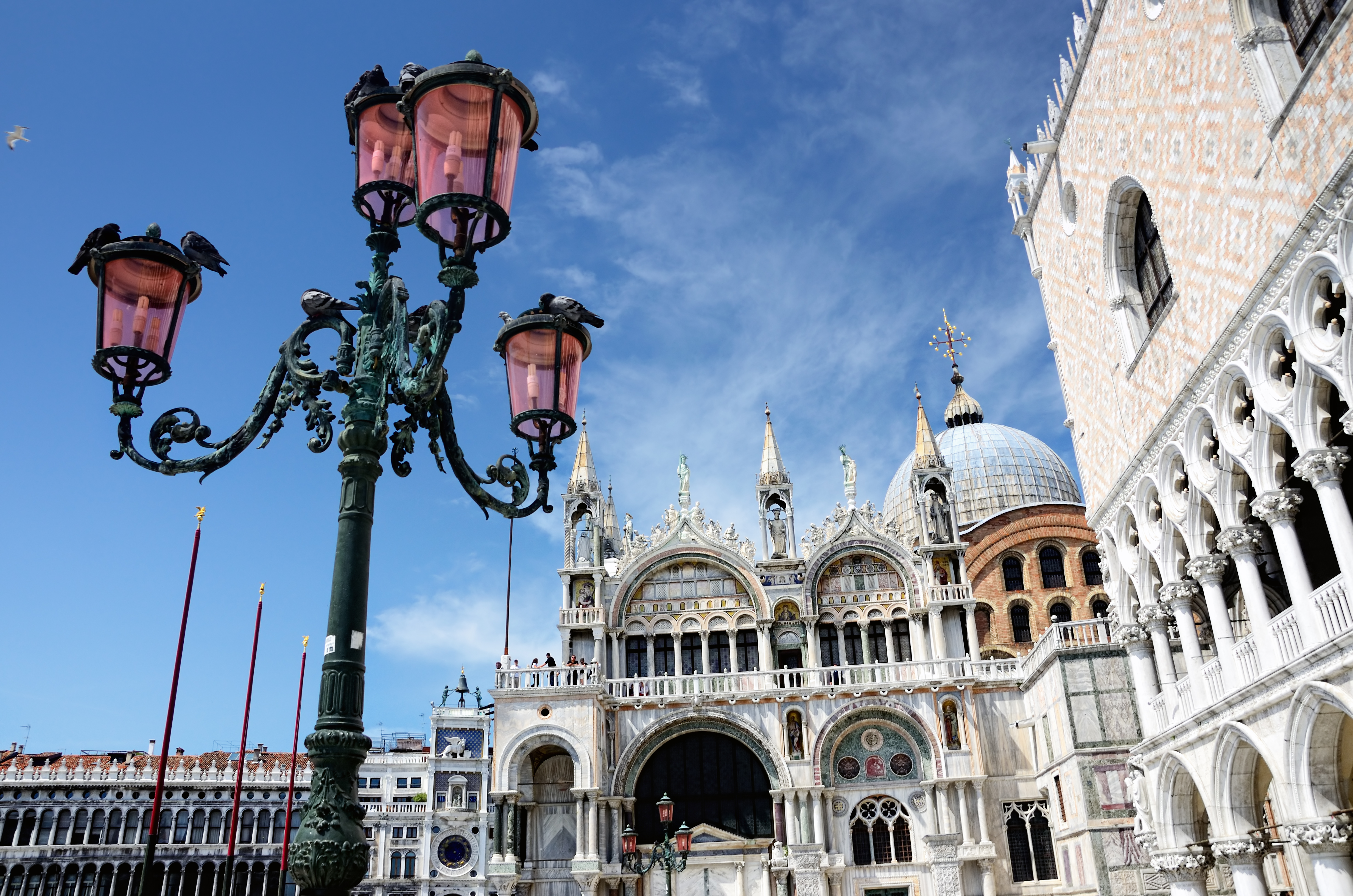 Iron lamp outside St Mark's Basilica and pink Doge's Palace in Venice