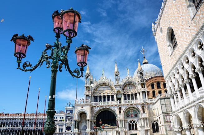 Iron lamp outside St Mark's Basilica and pink Doge's Palace in Venice