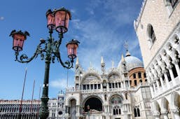Iron lamp outside St Mark's Basilica and pink Doge's Palace in Venice