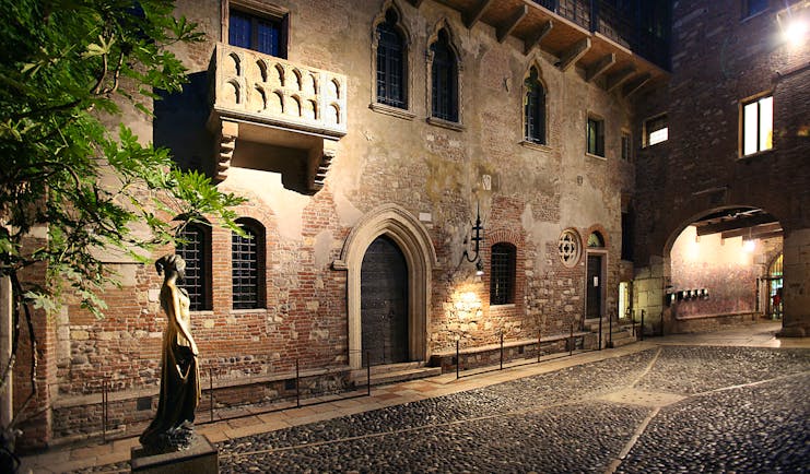 Hotel exterior of big stone building, large arching entrance door