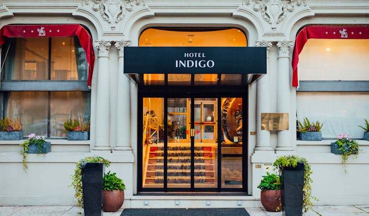 Front entrance to hotel with plants outside