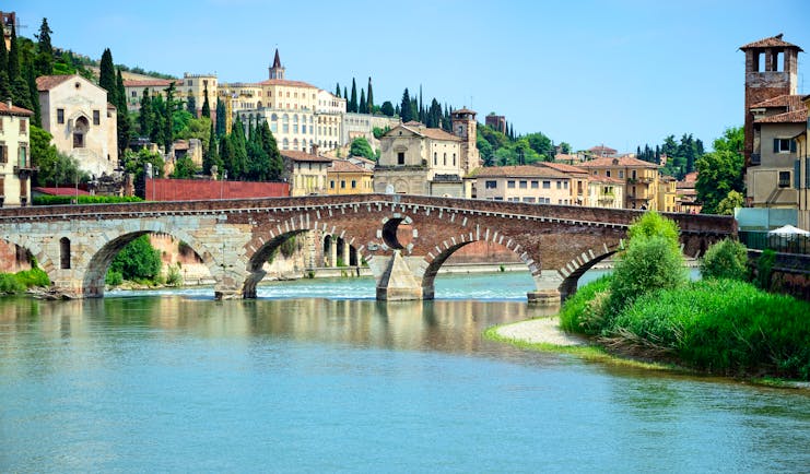Roman stone bridge over the blue waters of the river Adige in Verona