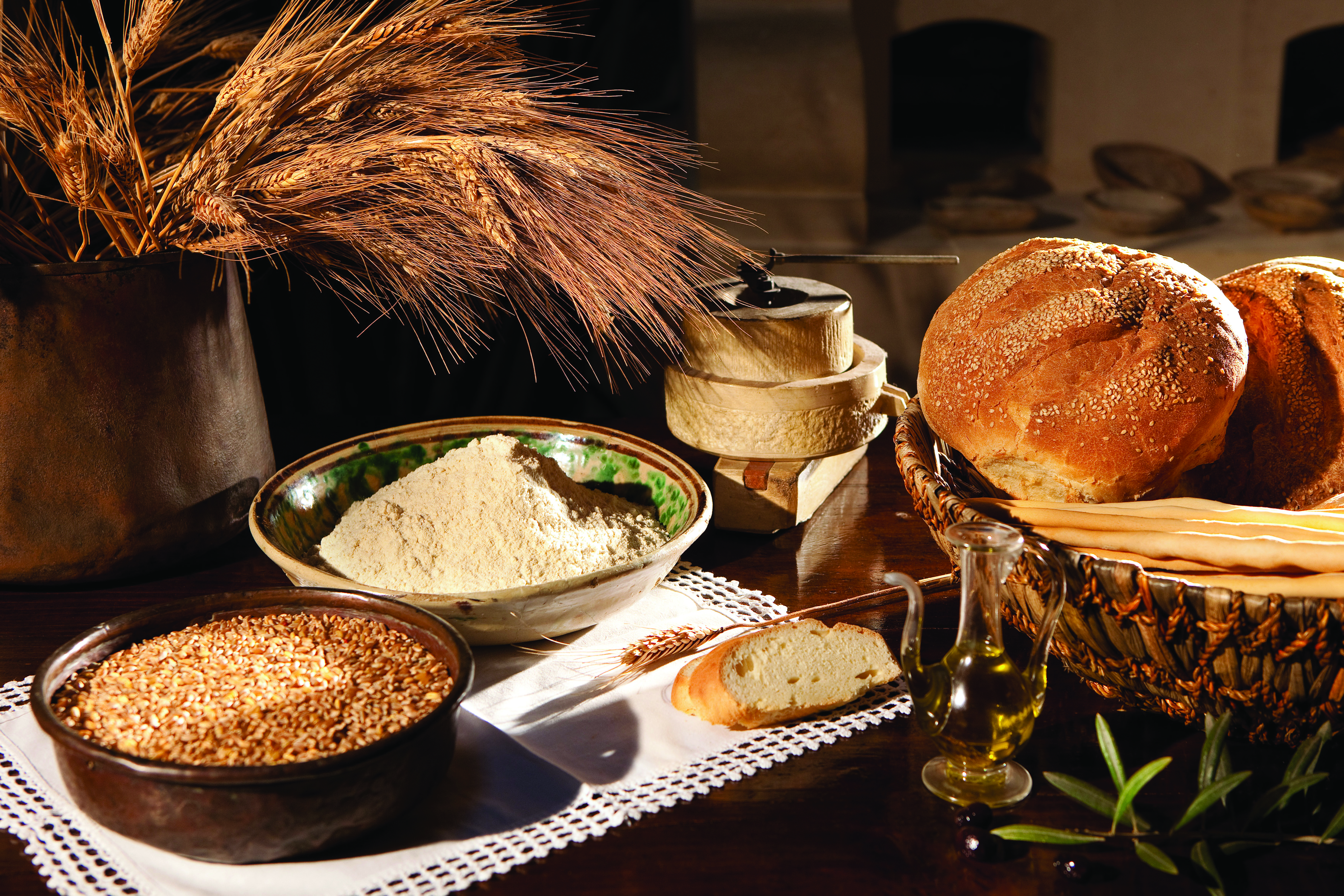 Rounds of bread and bowls of grain on table