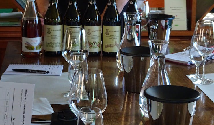 Bottles and glasses of wine on table for tasting