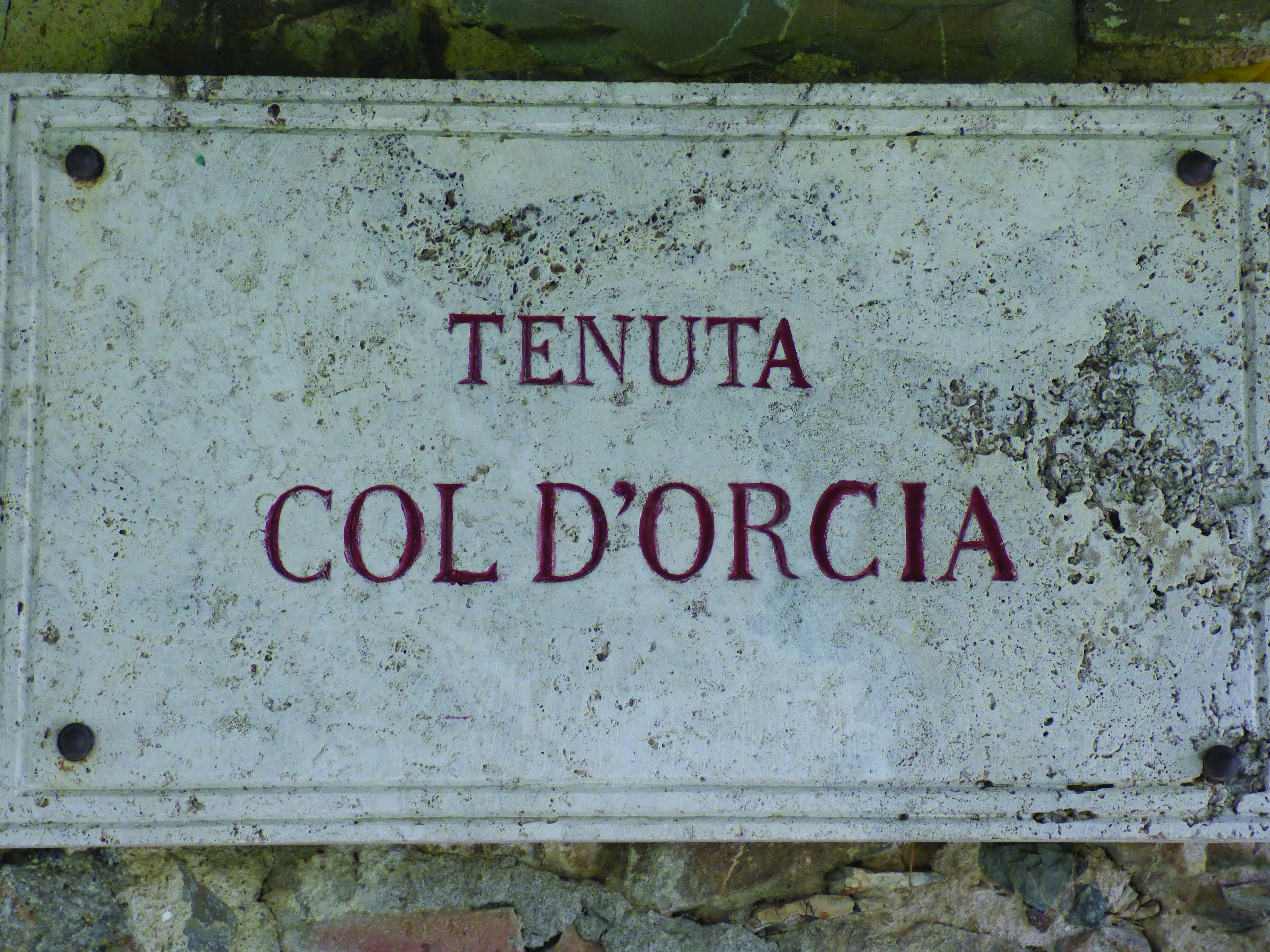 Sign on wall white with red lettering Tenuta Col d'Orcia Tuscany